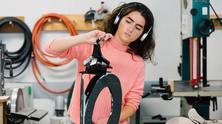 USF student working on sculpture in studio