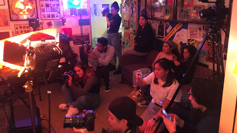 Group of USF students filming for class in a dorm room