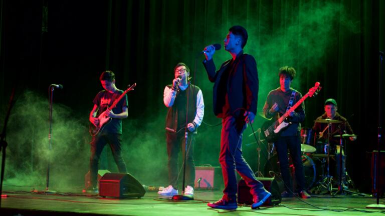 Student musicians in rock band concert