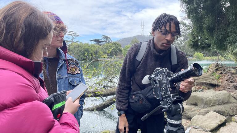 Three students filming