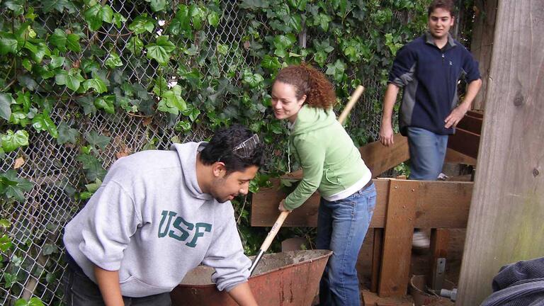 Three students shoveling