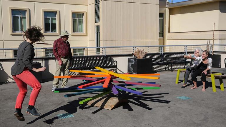 People performing on a rooftop.