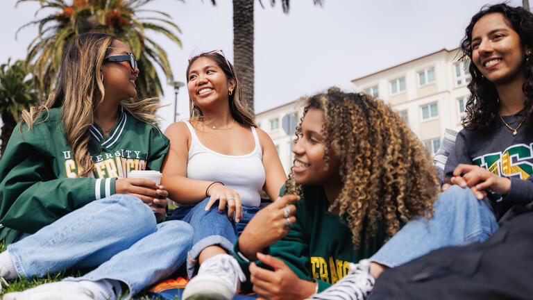 students sitting on grass