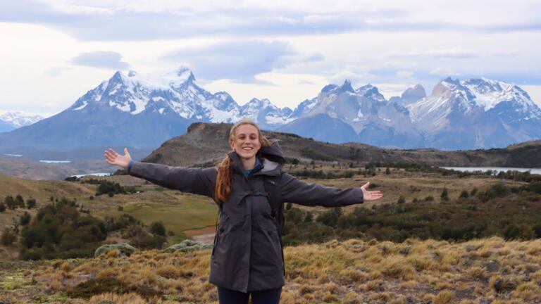 a student taking a mountain hike while studying abroud