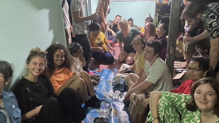 students gather in their room while on an immersion trip