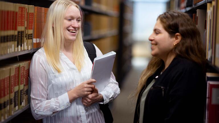 Students talking in a library