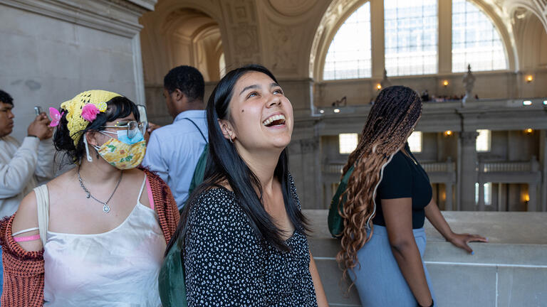 student smiling inside the Beaux-Arts monument 