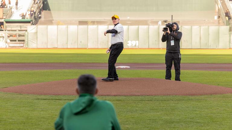 President Fr. Paul J. Fitzgerald, S.J. throws the first pitch