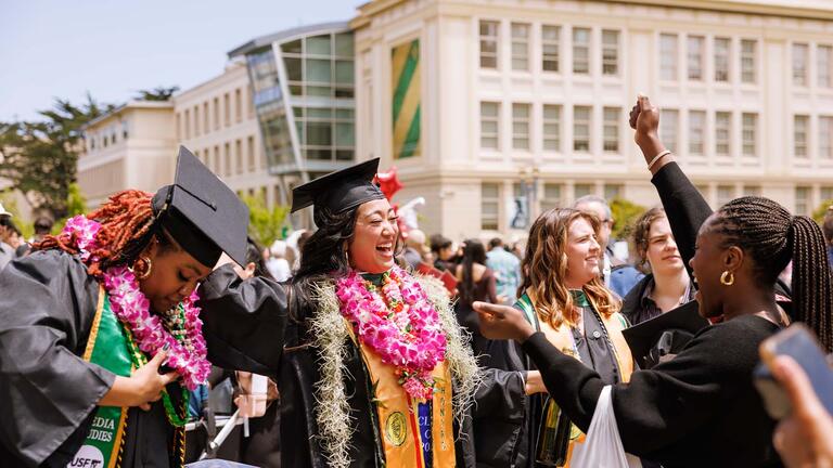 Graduates celebrating in Gleeson Plaza