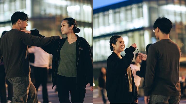 Students dancing together on campus in the evening