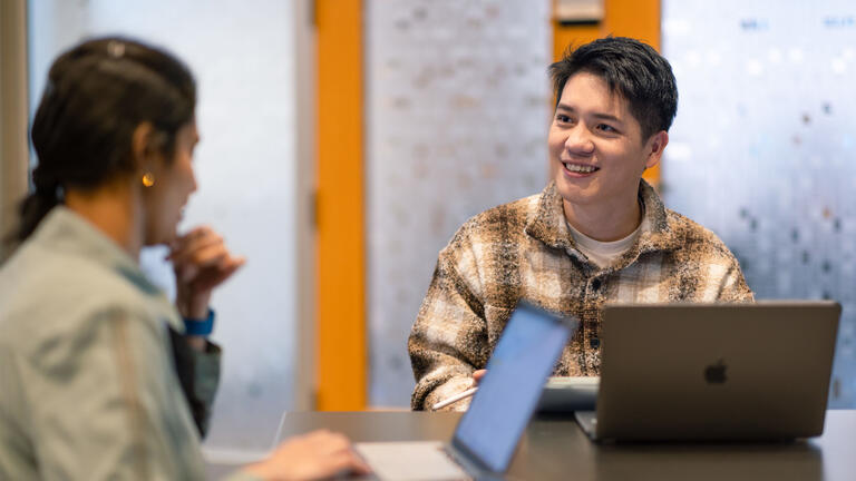 Two students chatting during class
