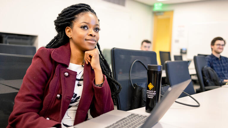 student sitting at table in class