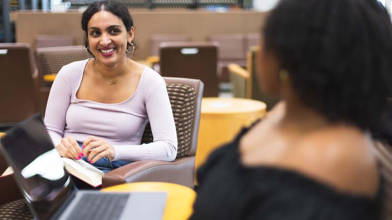 Two students sitting and talking