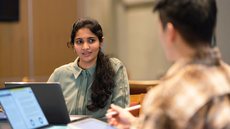 Two USF students working together