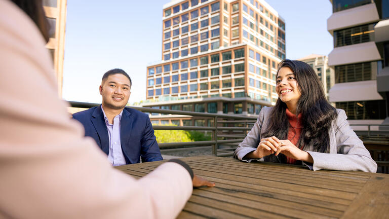 graduate students sitting at table at downtown campus