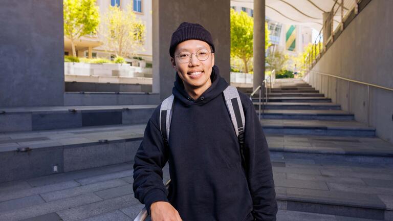 student posing for the camera on campus