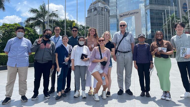 USF International Studies students join students from Universitas Tarumanagara, touring Jakarta's Central Business District as part of the urban development immersion course. International Studies students and Professor Zarobell visiting Kampung Rawa in Jakarta. USF International Studies and Universitas Tarumanagara students, after presenting their policy proposal to a panel of experts for the urban development skills class. International Studies students, faculty, and staff at the spring capstone poster pr