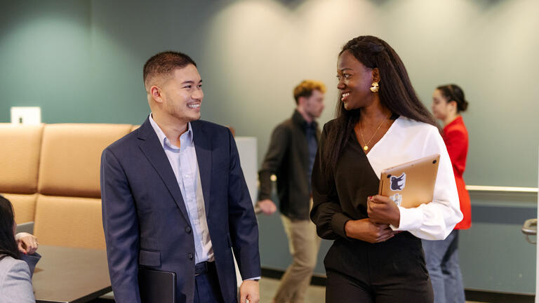 Two students smiling.