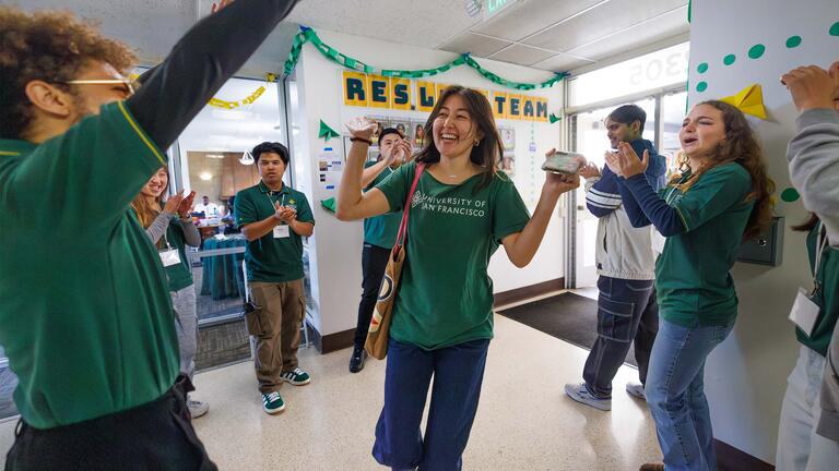 Res Life Team cheering each other on in a residence hall at USF