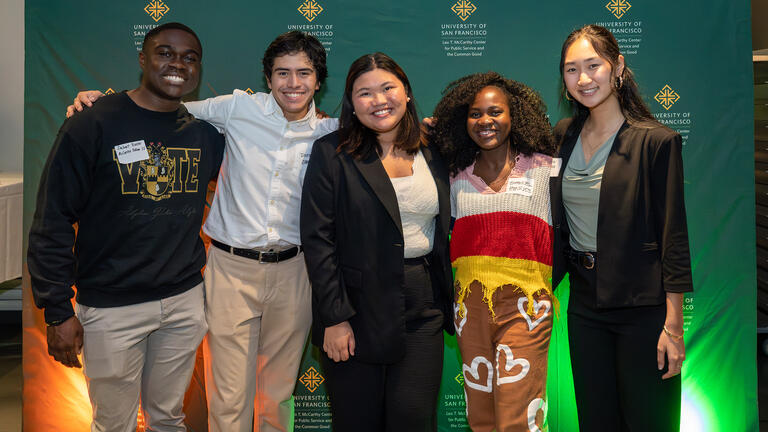 group of usf students smile for photo