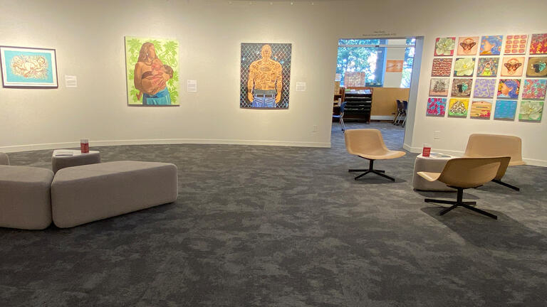 Taken Root installation photograph featuring prints and mixed media works