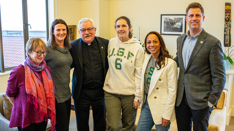 Tara August posing with other members of USF community