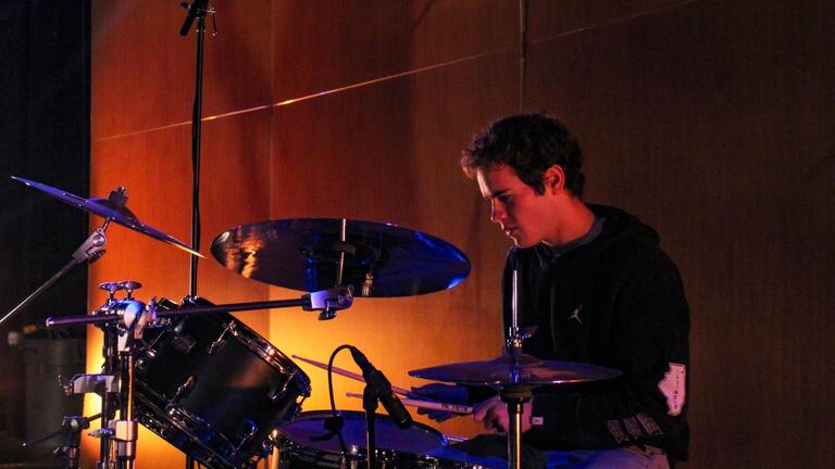 Student drummer performing on stage