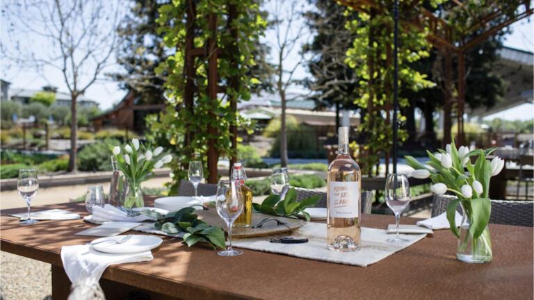 Table setting with flowers and a bottle of wine