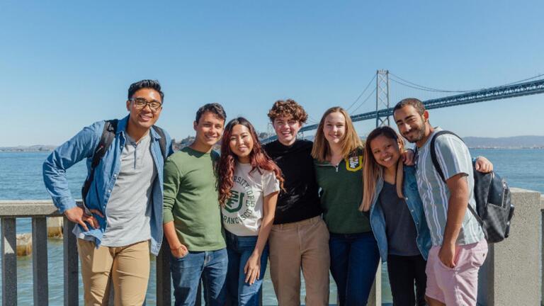 Students pose near the Bay Bridge