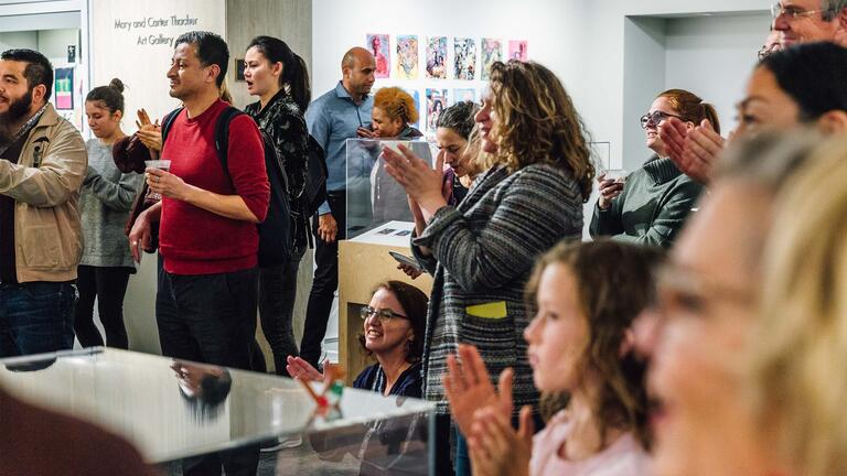 Group of visitors to Thacher Gallery clapping