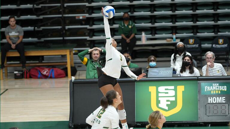 usf volleyball player jumps to return ball over net
