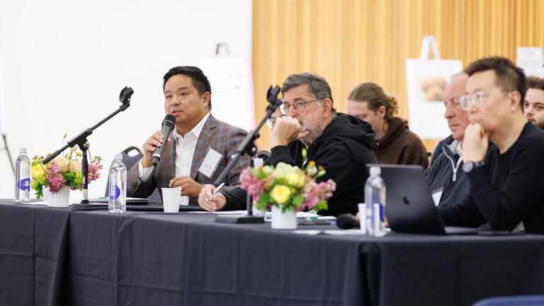 Three people on a panel speaking at Innovation Summit