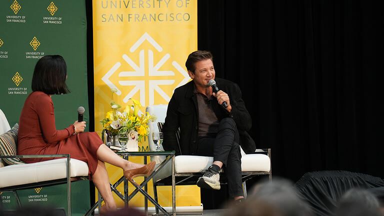 Jeremy Renner on stage at the Silk Speaker Series with Vickey Nguyen