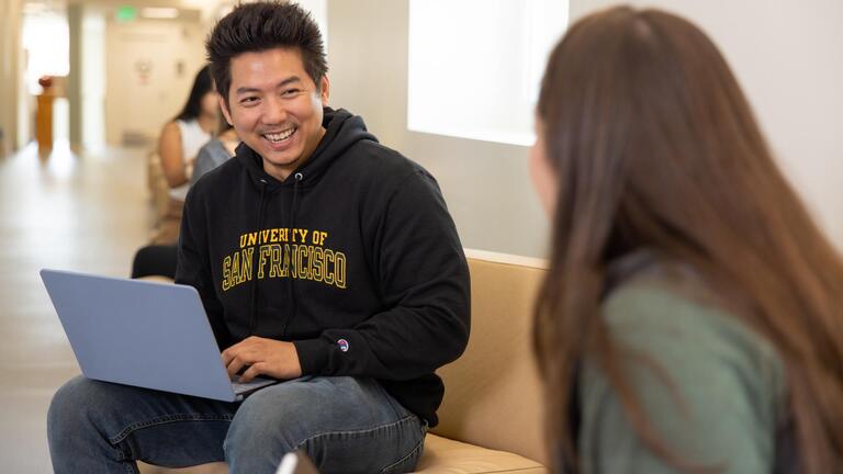 Student with laptop at Orange County Campus
