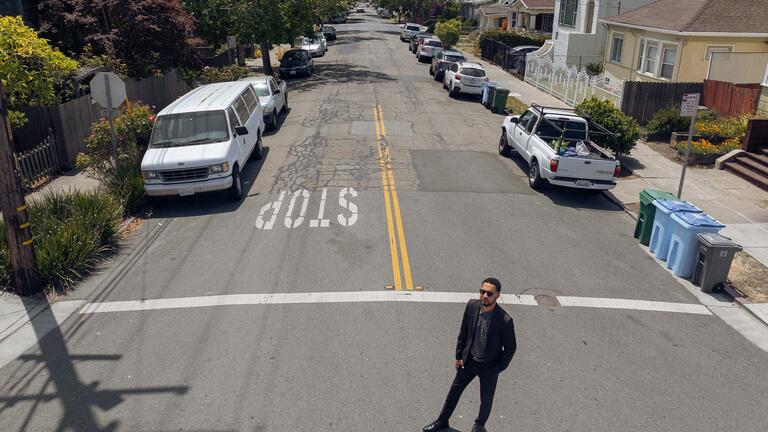 Person standing in a crosswalk on the street