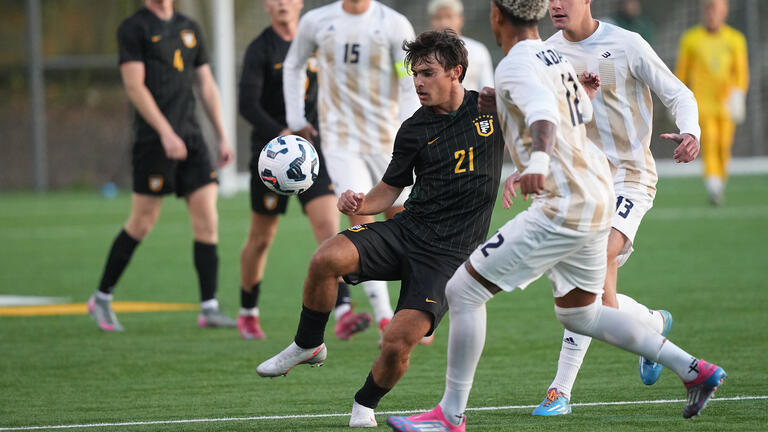 student prepares to kick soccer ball