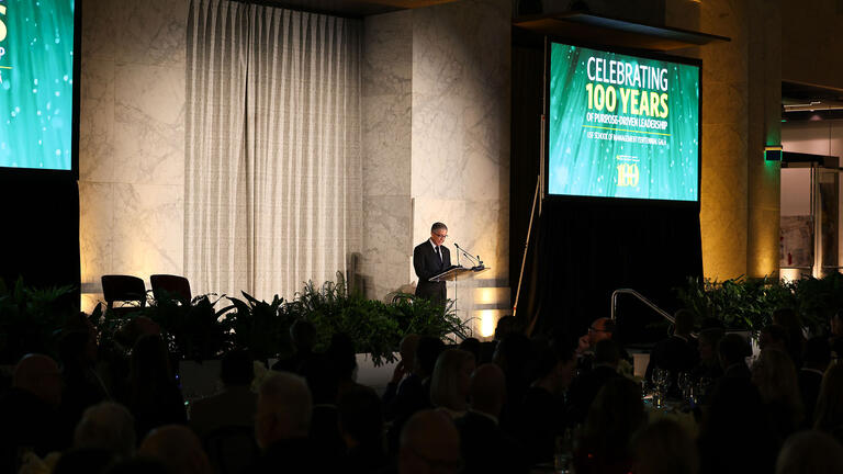 USF President Aceves speaking on stage at the School of Management’s 100th Anniversary at Centennial Gala