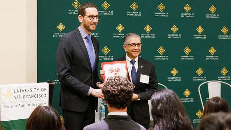 Senator Wiener presents Aceves with a certificate of recognition