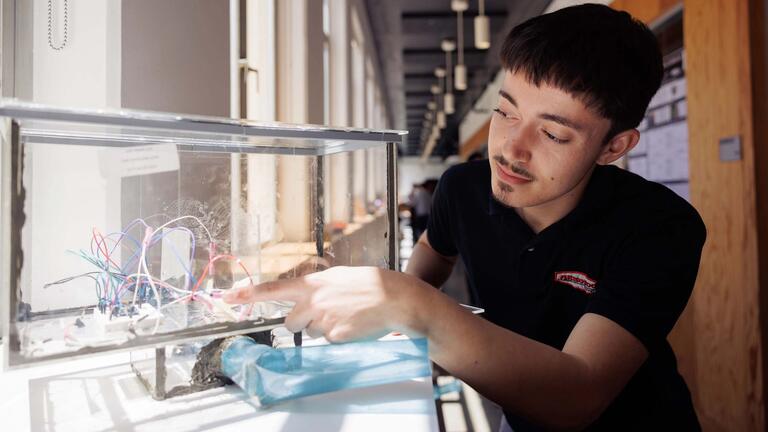 an engineering student assembles his new creation
