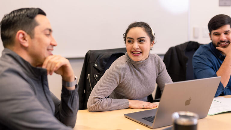 Three students chatting in class