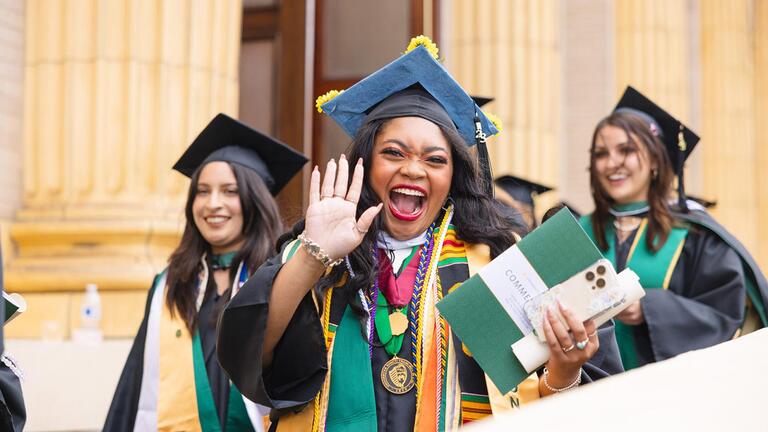student in cap in gown waves