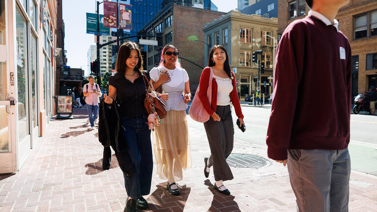 students walking side by side in downtown San Francisco