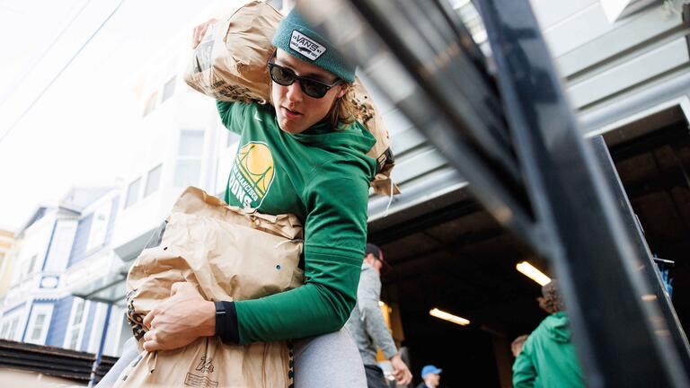 USF student helping to move donated food items onto a truck