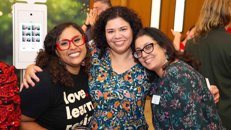Three people hugging for group photo