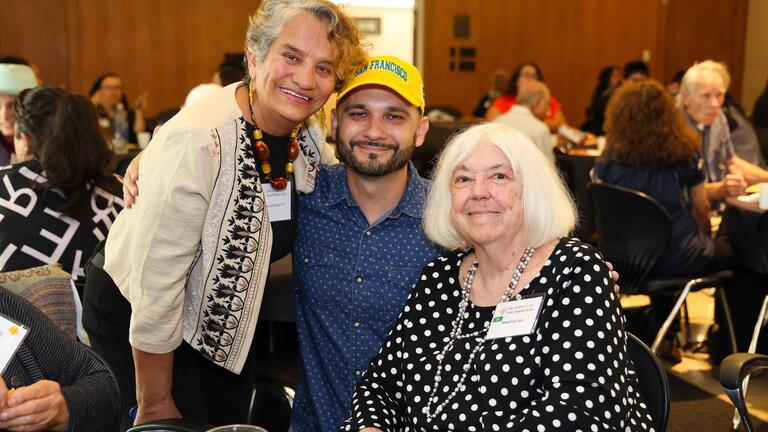 two older women and one younger man posing for a photo
