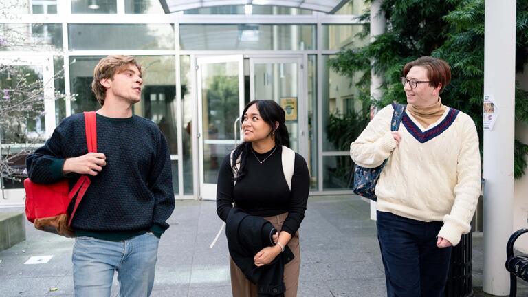 three students walking and talking
