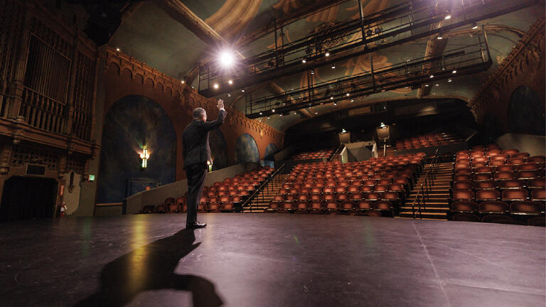 President Aceves on stage in Presentation Theater