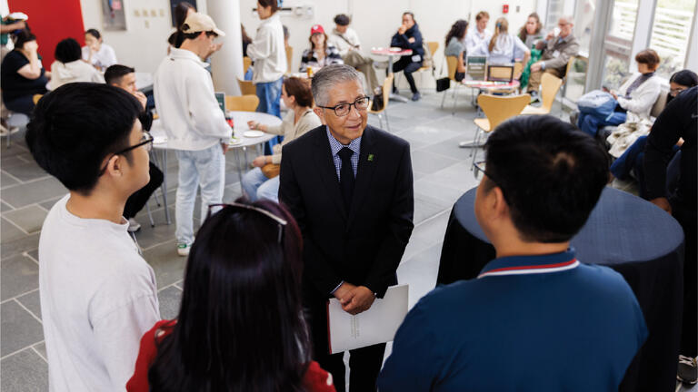 President Aceves talking with students
