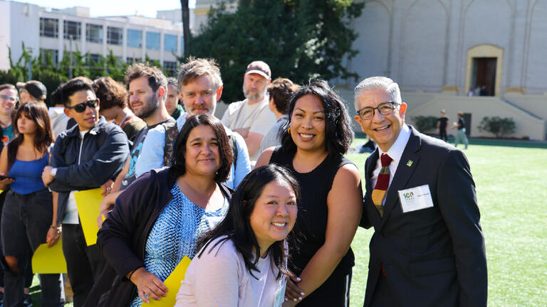 President Aceves posing with arts and sciences faculty and staff