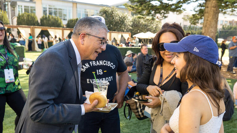President Aceves talking with arts and sciences faculty and staff